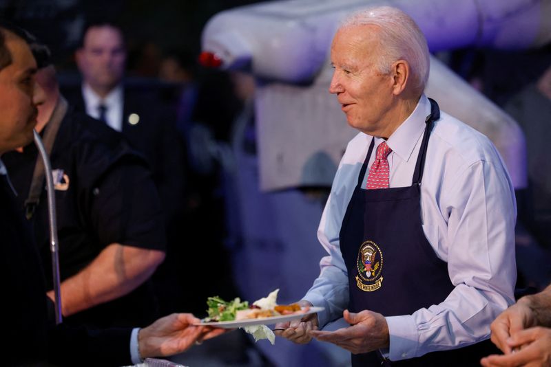 © Reuters. U.S. President Joe Biden serves food to service members and their families during a 
