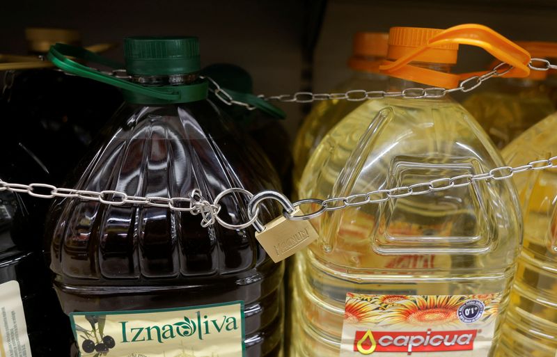 © Reuters. Olive and sunflower oil bottles are displayed for sale, protected by a padlock and a chain to prevent theft in a Tu Super Suma supermarket in Malaga, Spain, October 23, 2023. REUTERS/Jon Nazca/File Photo