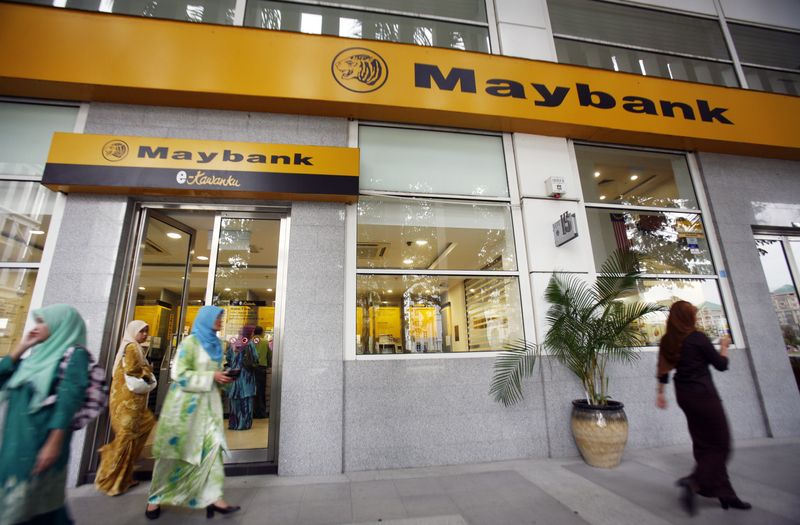 &copy; Reuters. Customers leave a branch of Malaysia's Maybank in Putrajaya October 9, 2009. REUTERS/Bazuki Muhammad/File Photo