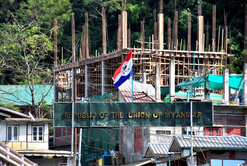 &copy; Reuters. FILE PHOTO: A flag of one of the Myanmar rebel forces is installed next to an under-construction structure in Myanmar's Khawmawi village on the India-Myanmar border as seen from Zokhawthar village in Champhai district of India's northeastern state of Mizo