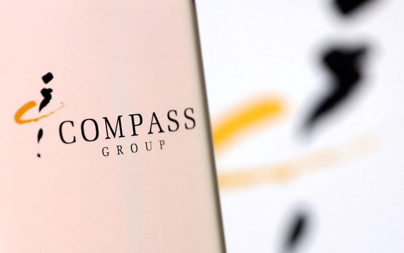 &copy; Reuters. FILE PHOTO: Compass Group's logo is pictured on a smartphone in this illustration taken, December 4, 2021. REUTERS/Dado Ruvic/Illustration/File Photo
