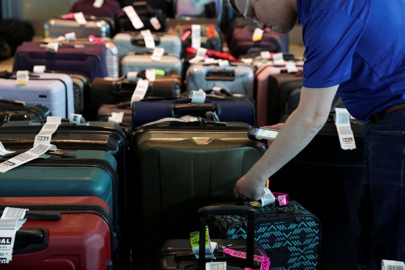 © Reuters. FILE PHOTO: Airline employees assist passengers in locating their luggage at Dallas Love Field Airport in Dallas, Texas, U.S., December 28, 2022.  REUTERS/Shelby Tauber/File Photo