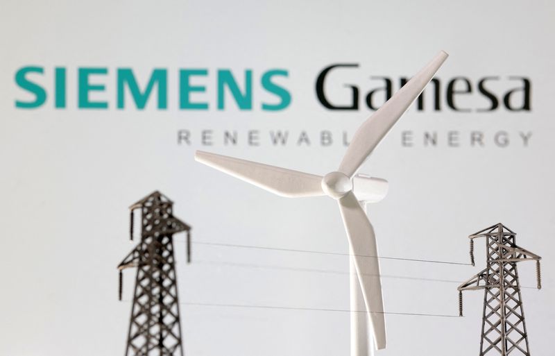 &copy; Reuters. Miniatures of windmill and electric pole are seen in front of Siemens Gamesa logo in this illustration taken January 17, 2023. REUTERS/Dado Ruvic/Illustration/File Photo