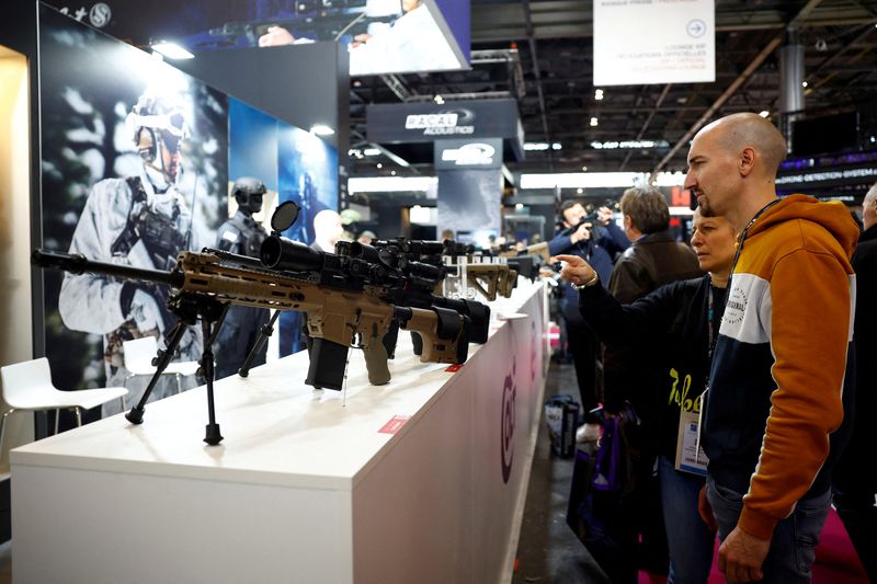 &copy; Reuters. FILE PHOTO: Visitors look at firearms from Colt CZ Group at the Milipol Paris, the worldwide exhibition dedicated to homeland security and safety, in Villepinte near Paris, France, November 15, 2023. REUTERS/Sarah Meyssonnier/File Photo