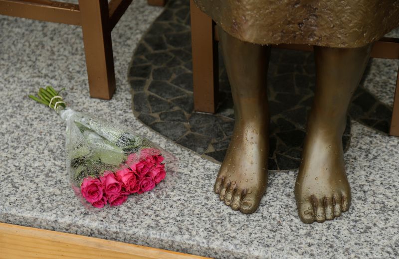 &copy; Reuters. FILE PHOTO: A bouquet lays alongside a statue commemorating Korean "comfort women" at a Sydney church in Sydney, Australia December 15, 2016, a 1.5-metre statue imported from Korea which has been a flashpoint for tensions between Korean and Japanese commu