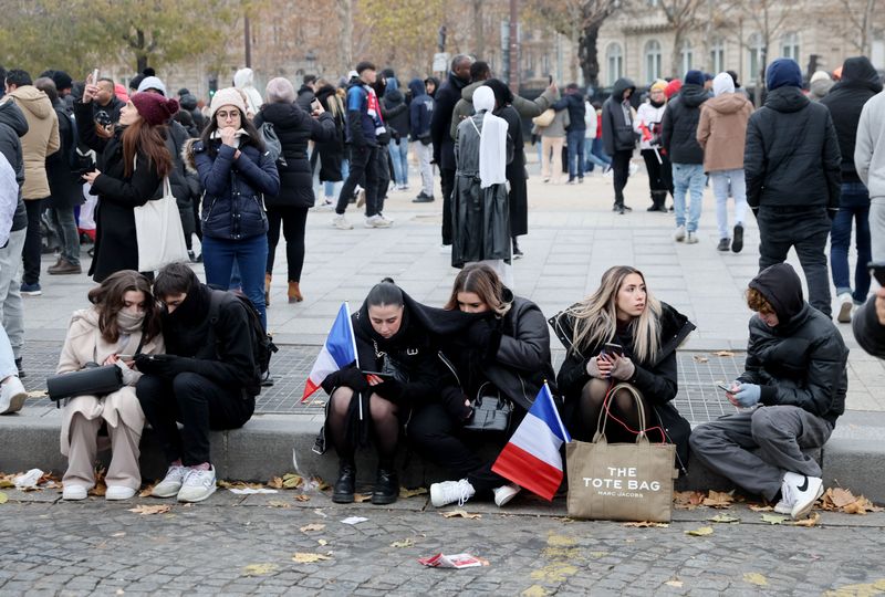 &copy; Reuters. Soccer Football - FIFA World Cup Final Qatar 2022 - France fans react on the Champs-Elysees during the final between France and Argentina - Paris, France - December 18, 2022 France fans are pictured on the Champs-Elysees as they watch the final on their p