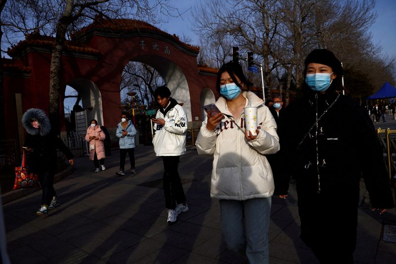 &copy; Reuters. Imagen de archivo de personas con mascarillas en un calle de Pekín, China. 14 febrero 2023. REUTERS/Tingshu Wang