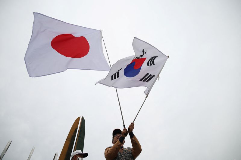&copy; Reuters. A member of a conservative civic group waves national flags of Japan and South Korea during a pro-Japan rally near the Presidential Office in Seoul, South Korea, May 7, 2023.  REUTERS/Kim Hong-Ji/ File Photo