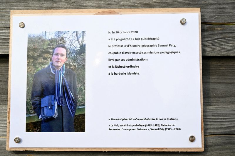 &copy; Reuters. FILE PHOTO: A photograph taken on October 16, 2023 shows a commemorative plaque for slain teacher Samuel Paty (portrait) near the Bois d'Aulne school in Conflans-Sainte-Honorine, outside Paris.  BERTRAND GUAY/Pool via REUTERS/File Photo