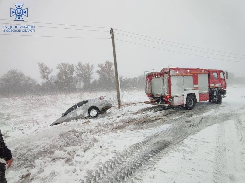 © Reuters. Emergency workers release a car which is stuck in snow during a heavy snow storm in Odesa region, Ukraine in this handout picture released November 27, 2023. Press service of the State Emergency Service of Ukraine in Odesa region/Handout via REUTERS