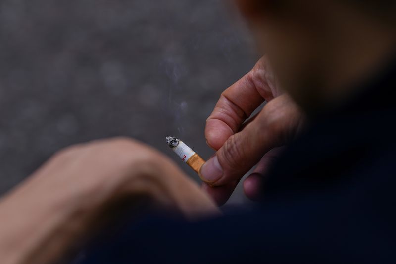 &copy; Reuters. A man holds a cigarette in his hands in London, Britain April 11, 2023. REUTERS/Maja Smiejkowska/File Photo