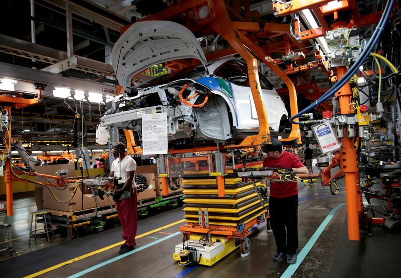 &copy; Reuters. FILE PHOTO: General Motors assembly workers connect a battery pack underneath a partially assembled 2018 Chevrolet Bolt EV vehicle on the assembly line at  Orion Assembly in Lake Orion, Michigan, U.S., March 19, 2018. REUTERS/Rebecca Cook/File Photo