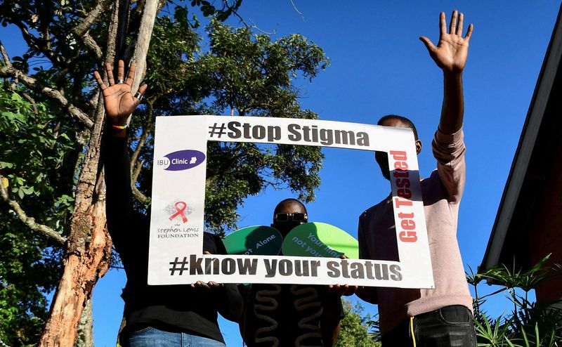 &copy; Reuters. FILE PHOTO: HIV/AIDS patients and LGBTQ members hold an advocacy placard at the Ice Breakers Uganda (IBU) clinic in Makindye that supports HIV/AIDS programmes and treatment for the LGBTQ community in Salaama road, Kampala, Uganda June 1, 2023. REUTERS/Abu