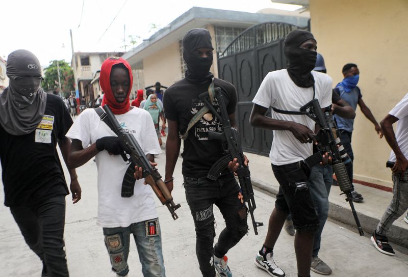 &copy; Reuters. FILE PHOTO: Former police officer Jimmy "Barbecue" Cherizier (not pictured), leader of the 'G9' coalition, is accompanied by Security during a march against Haiti's Prime Minister Ariel Henry, in Port-au-Prince, Haiti September 19, 2023. REUTERS/Ralph Ted