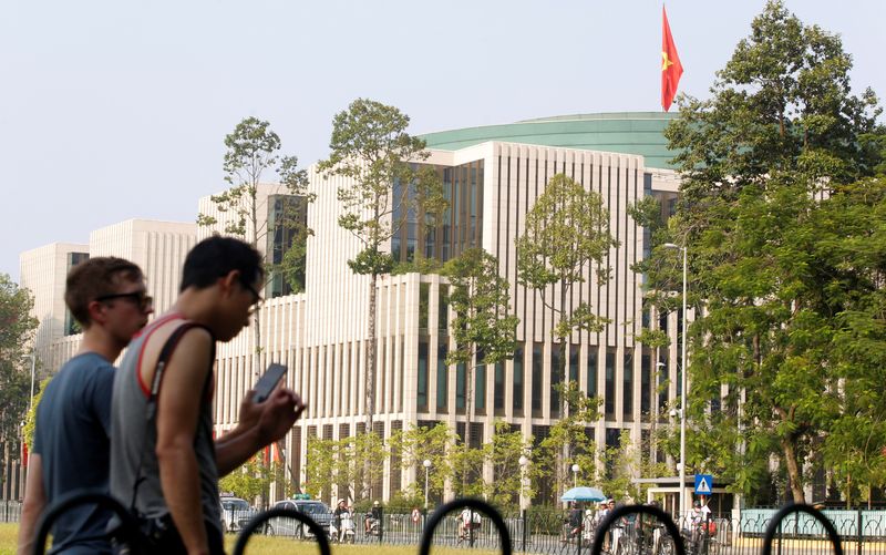 &copy; Reuters. FILE PHOTO: Tourists walk past Vietnam's National Assembly (Parliament) building in Hanoi, Vietnam, September 16, 2016. REUTERS/Kham/File Photo