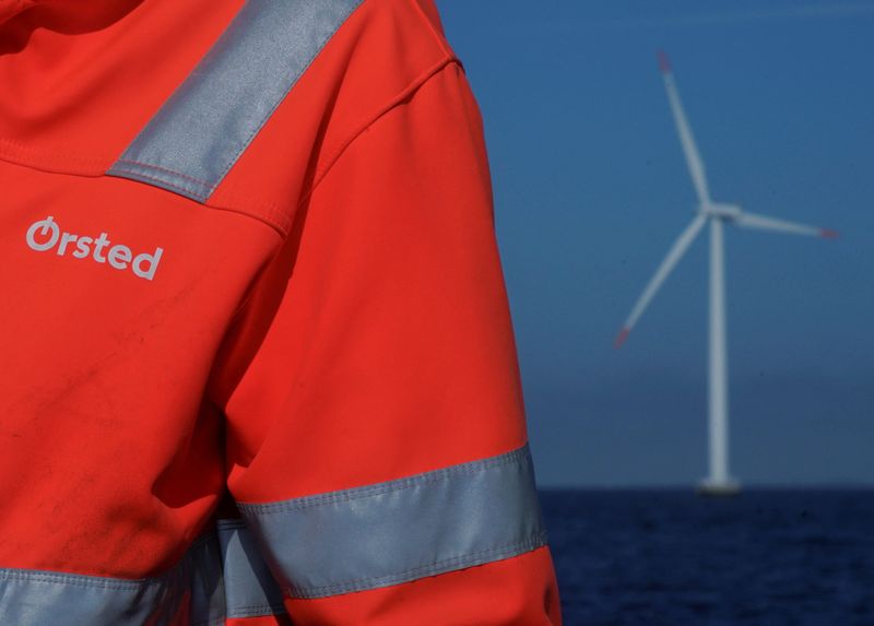 &copy; Reuters. FILE PHOTO: The logo for Orsted can be seen on the jacket worn by an employee as he talks to journalists during a visit to the offshore wind farm near Nysted, Denmark, September 4, 2023. REUTERS/Tom Little