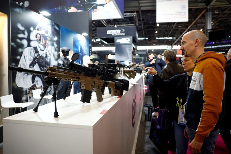 &copy; Reuters. FILE PHOTO: Visitors look at firearms from Colt CZ Group at the Milipol Paris, the worldwide exhibition dedicated to homeland security and safety, in Villepinte near Paris, France, November 15, 2023. REUTERS/Sarah Meyssonnier