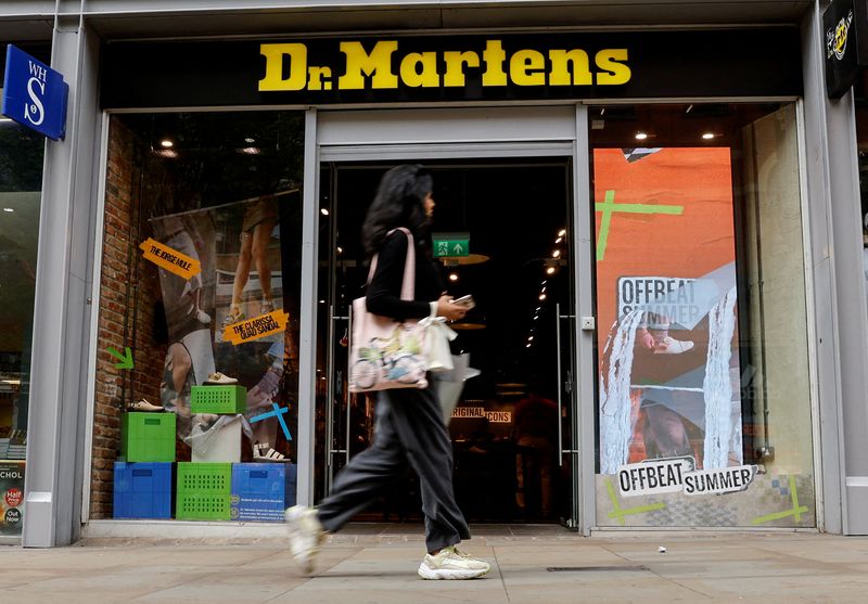 &copy; Reuters. FILE PHOTO: A woman walks past a Dr. Martens store in Manchester, Britain, May 26, 2023. REUTERS/Jason Cairnduff/File Photo