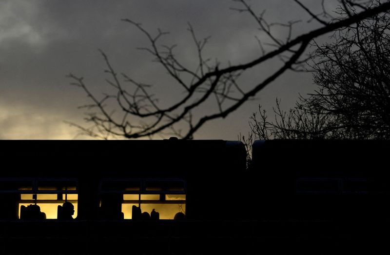 &copy; Reuters. FILE PHOTO: A passenger is silhouetted on a train crossing the river Thames as British railway workers strike over pay and conditions, in Richmond, London, Britain, February 3, 2023. REUTERS/Toby Melville/File Photo