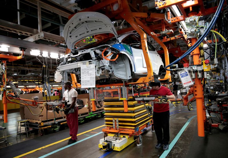 &copy; Reuters. FILE PHOTO: General Motors assembly workers connect a battery pack underneath a partially assembled 2018 Chevrolet Bolt EV vehicle on the assembly line at  Orion Assembly in Lake Orion, Michigan, U.S., March 19, 2018. REUTERS/Rebecca Cook/File Photo/File 