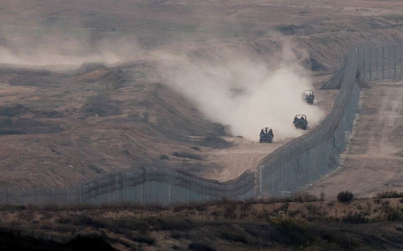 &copy; Reuters. FILE PHOTO: Military vehicles manoeuvre next to a fence, as seen from the Israeli side of the border with Gaza, November 5, 2023. REUTERS/Ronen Zvulun/File Photo