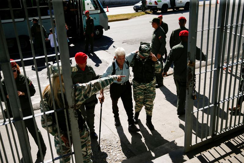 &copy; Reuters. Officers help a man on the day of an electoral referendum over Venezuela's rights to the potentially oil-rich region of Esequiba, which has long been the subject of a border dispute between Venezuela and Guyana, in Caracas, Venezuela December 3, 2023. REU