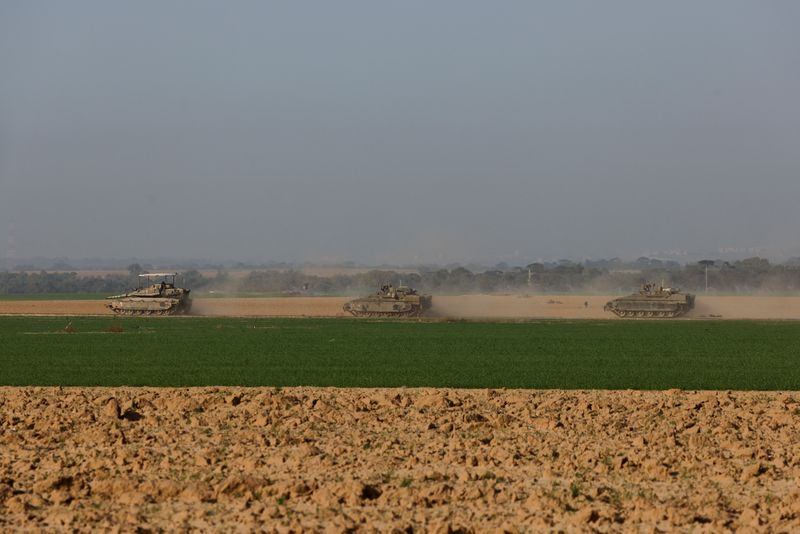 &copy; Reuters. An Israeli tank and armored personnel carriers (APC) maneuver near Israel's border with southern Gaza, amid the ongoing conflict between Israel and the Palestinian Islamist group Hamas, in Israel, December 4, 2023. REUTERS/Amir Cohen
