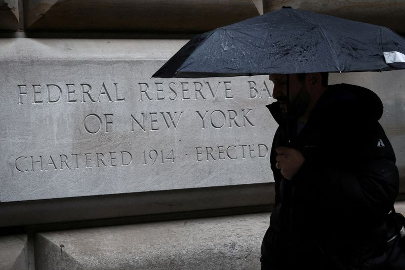 © Reuters. FILE PHOTO: A man passes by The Federal Reserve Bank of New York in New York City, U.S., March 13, 2023.  REUTERS/Brendan McDermid/File Photo