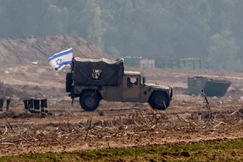 &copy; Reuters. An Israeli flag flies on a military vehicle as the Israeli army operates at the border with Gaza, amid the ongoing conflict between Israel and the Palestinian Islamist group Hamas, as seen from southern Israel, December 5, 2023. REUTERS/Athit Perawongmeth
