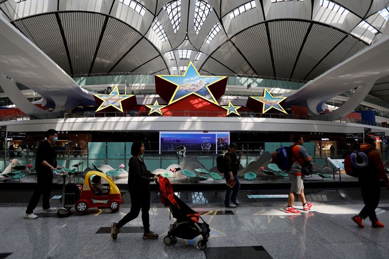 &copy; Reuters. FOTO DE ARCHIVO. Viajeros pasan junto a una instalación en forma de cinco estrellas, en el Aeropuerto Internacional de Pekín Daxing en Pekín, China. 24 de abril de 2023. REUTERS/Tingshu Wang