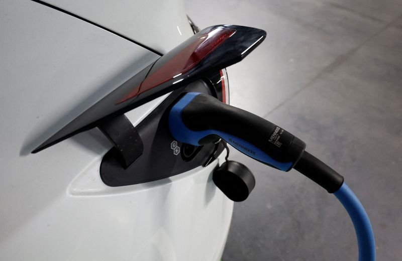 &copy; Reuters. FILE PHOTO: A Tesla electric vehicle is plugged to a charger in a parking lot in Teia, north of Barcelona, Spain, October 31, 2023. REUTERS/Albert Gea/File Photo