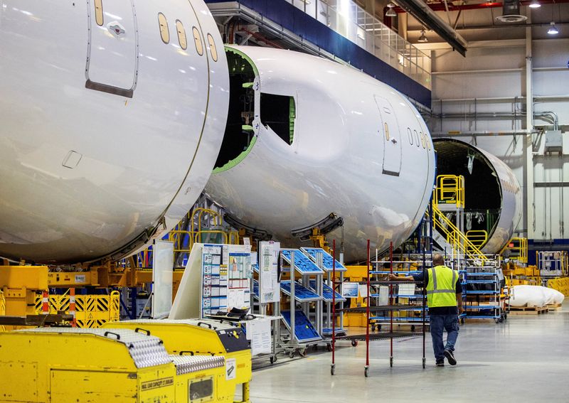 © Reuters. FILE PHOTO: An employee walks past a fuselage section under construction at Boeing Co.'s 787 Dreamliner campus in North Charleston, South Carolina, U.S., May 30, 2023. Gavin McIntyre/File Photo