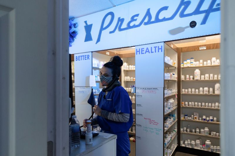© Reuters. Isabelle Lawler, a pharmacy student, answers calls at Skippack Pharmacy in Schwenksville, Pennsylvania, U.S., February 26, 2021. Picture taken February 26, 2021.  REUTERS/Hannah Beier/ File photo