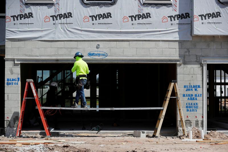 &copy; Reuters. A carpenter works on building new townhomes that are still under construction while building material supplies are in high demand in Tampa, Florida, U.S., May 5, 2021.  REUTERS/Octavio Jones