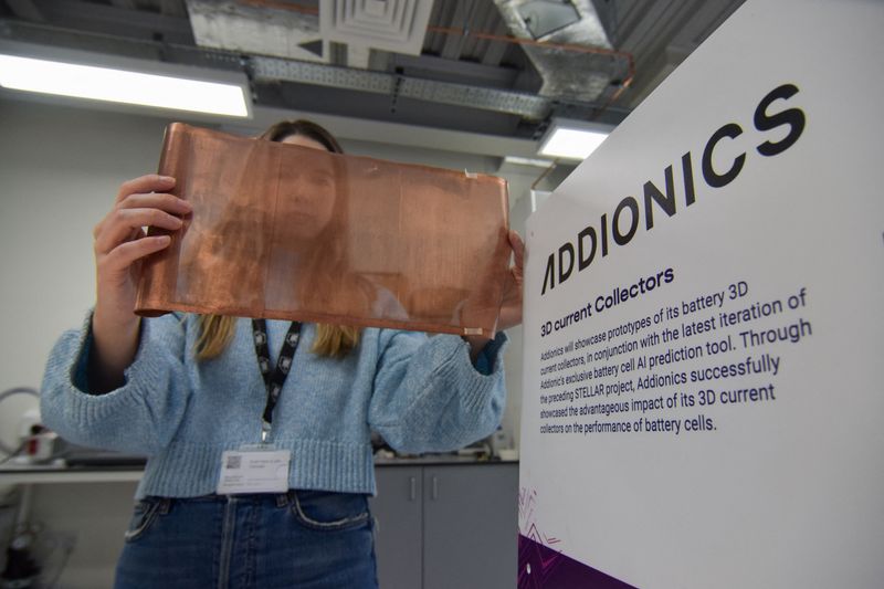 &copy; Reuters. Bernadett Vejkey, marketing manager at Addionics, holds up a sheet of a porous, three-dimensional copper anode the battery materials startup has developed for electric vehicle batteries, at the company's lab in London, Britain, December 5, 2023. REUTERS/N