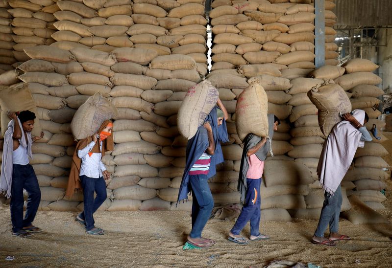 &copy; Reuters. Trabalhadores carregam sacas de trigo em moinho em Ahmedabad, Índia. REUTERS/Amit Dave/File Photo