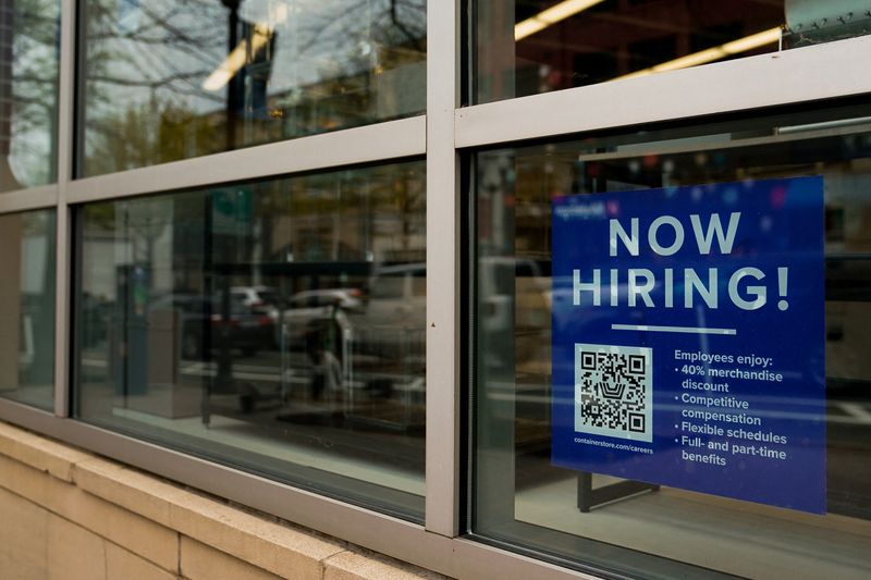 © Reuters. FILE PHOTO: An employee hiring sign with a QR code is seen in a window of a business in Arlington, Virginia, U.S., April 7, 2023. REUTERS/Elizabeth Frantz/File Photo