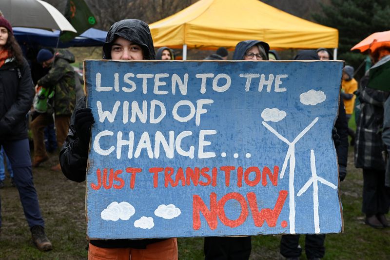 &copy; Reuters. An activist holds a sign, at a protest during the Global Day of Action for Climate Justice, coinciding with COP28, in Edinburgh, Scotland, Britain, December 9, 2023. REUTERS/Lesley Martin