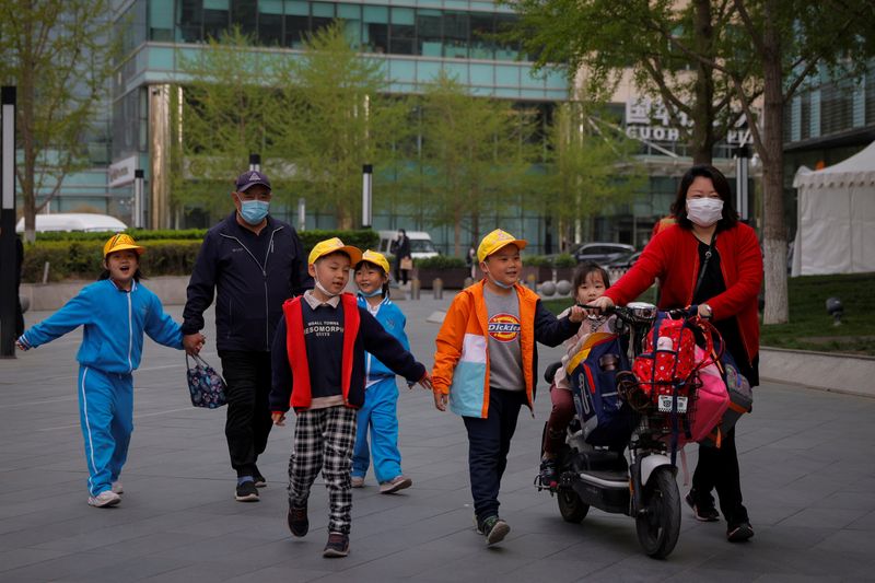 &copy; Reuters. FILE PHOTO: People pick up children from a school in Beijing, China, April 6, 2021. Picture taken April 6, 2021.   REUTERS/Thomas Peter/File Photo