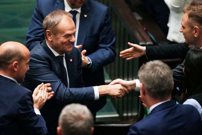 &copy; Reuters. Members of the Polish Parliament congratulate newly appointed Polish Prime Minister Donald Tusk after he won the vote of confidence for his government, in Parliament, in Warsaw, Poland December 12, 2023. REUTERS/Aleksandra Szmigiel    