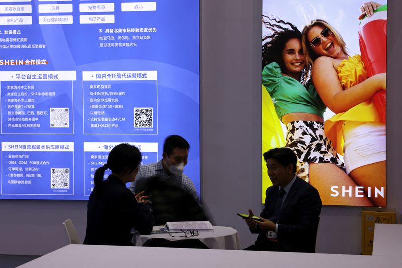 © Reuters. FILE PHOTO: People sit at the booth of fashion retailer Shein during the first China International Supply Chain Expo (CISCE) in Beijing, China November 28, 2023. REUTERS/Florence Lo/Files