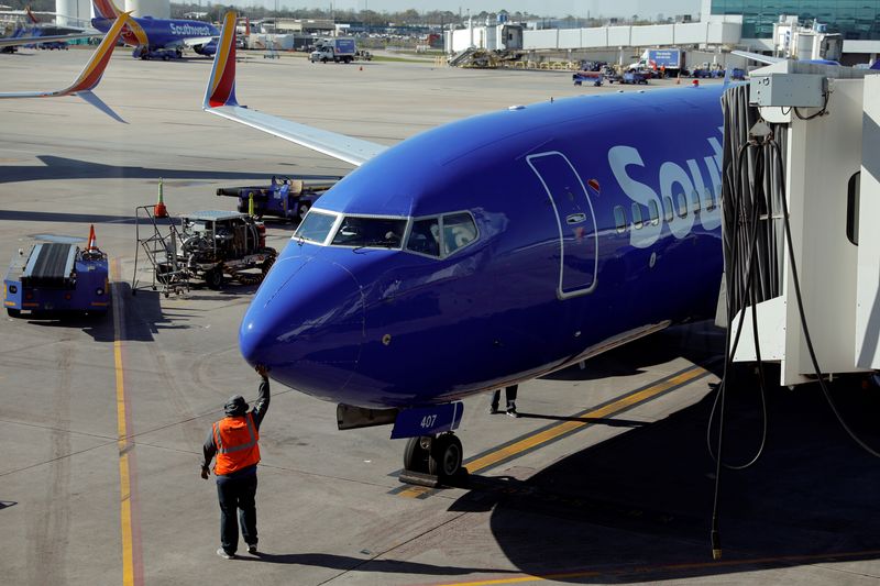 &copy; Reuters. FILE PHOTO: A Southwest grounds crew member pats the nose of a Boeing 737-700 plane as it comes to a stop at its gate at William P. Hobby Airport in Houston, Texas, February 20, 2019. REUTERS/Mike Blake/File Photo