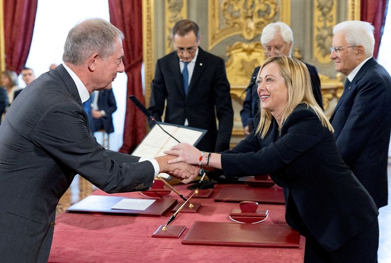 &copy; Reuters. FILE PHOTO: Italy's new Minister for Industry and Made in Italy (formerly Economic Development) Adolfo Urso shakes hands with Italy's Prime Minister Giorgia Meloni during the swearing-in ceremony at the Quirinale Presidential Palace, in Rome, Italy Octo