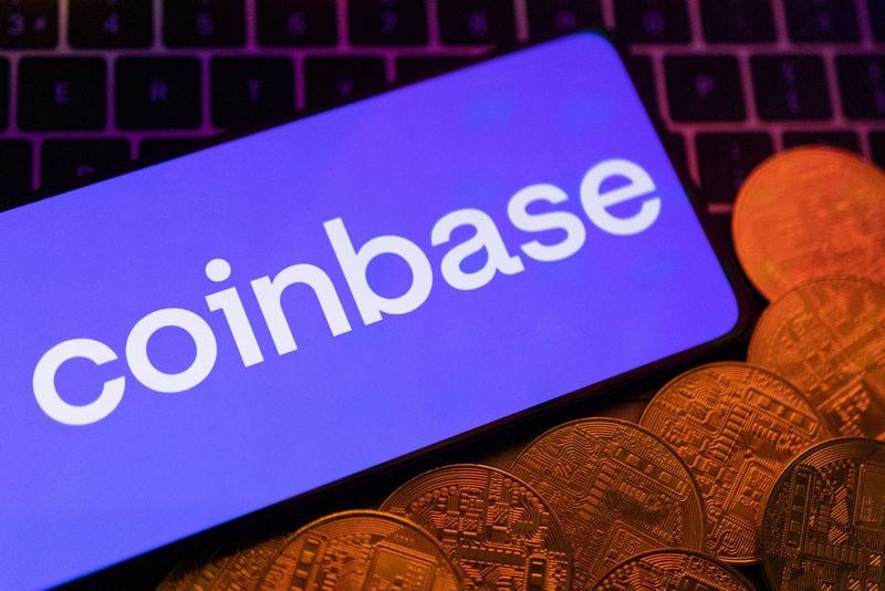 &copy; Reuters. Smartphone with displayed Coinbase logo and representation of cryptocurrencies are placed on a keyboard in this illustration taken, June 8, 2023. REUTERS/Dado Ruvic/Illustration