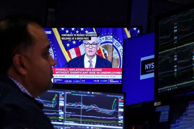 &copy; Reuters. FILE PHOTO: A trader works, as a screen displays a news conference by Federal Reserve Board Chairman Jerome Powell following the Fed rate announcement, on the floor of the New York Stock Exchange (NYSE) in New York City, U.S., December 13, 2023.  REUTERS/