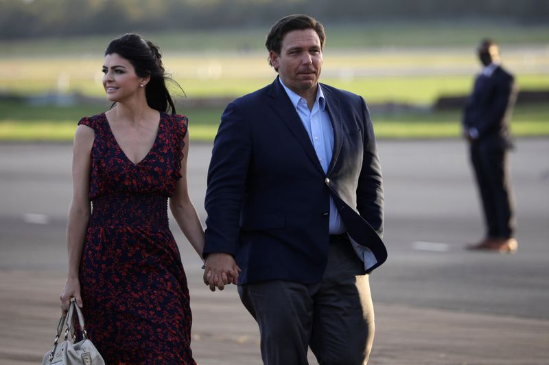 &copy; Reuters. Florida Governor Ron DeSantis and his wife Casey DeSantis walk at Ocala International Airport in Ocala, Florida, U.S. October 23, 2020. REUTERS/Tom Brenner/ File Photo