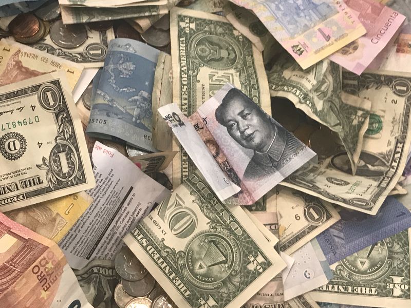 &copy; Reuters. U.S. dollars and other world currencies lie in a charity receptacle at Pearson international airport in Toronto, Ontario, Canada June 13, 2018. REUTERS/Chris Helgren/file photo