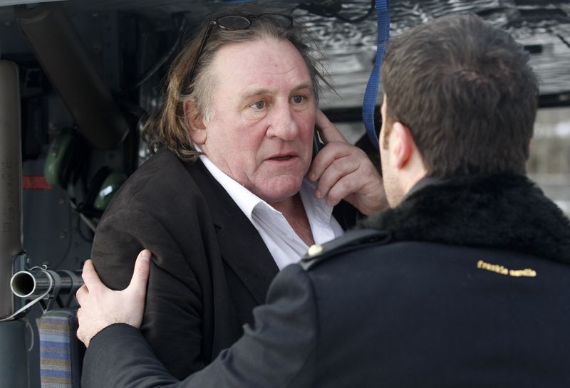 &copy; Reuters. French actor Gerard Depardieu talks on a mobile phone while sitting in a helicopter after visiting Cetinje January 8, 2013. REUTERS/Stevo Vasiljevic/File photo