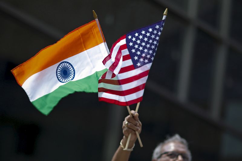 &copy; Reuters. A man holds the flags of India and the U.S. while people take part in the 35th India Day Parade in New York August 16, 2015. REUTERS/Eduardo Munoz/ File Photo