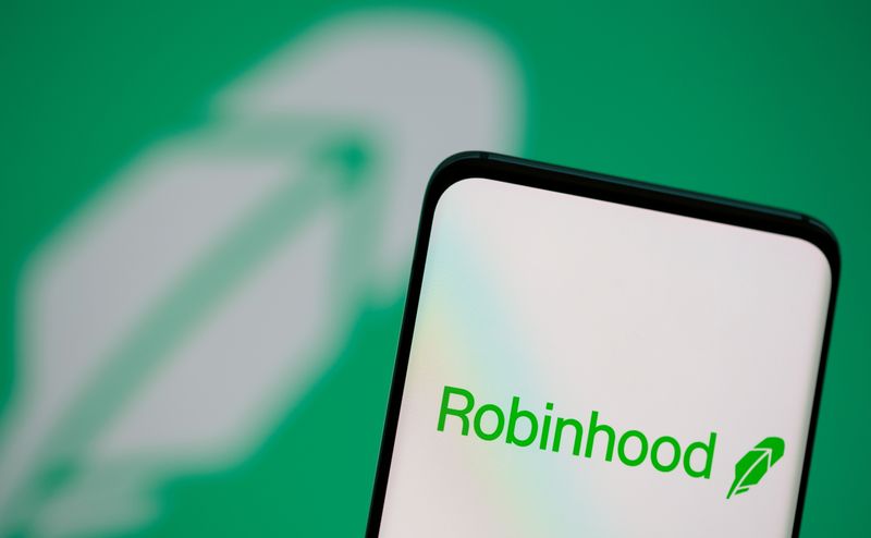 &copy; Reuters. Robinhood logo is seen on a smartphone in front of a displayed same logo in this illustration taken, July 2, 2021. REUTERS/Dado Ruvic/Illustration/File Photo